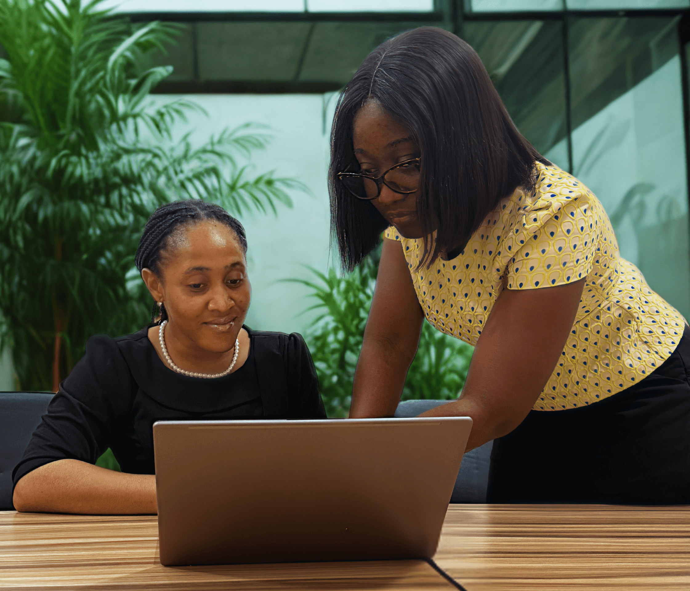 Two people working together on a laptop